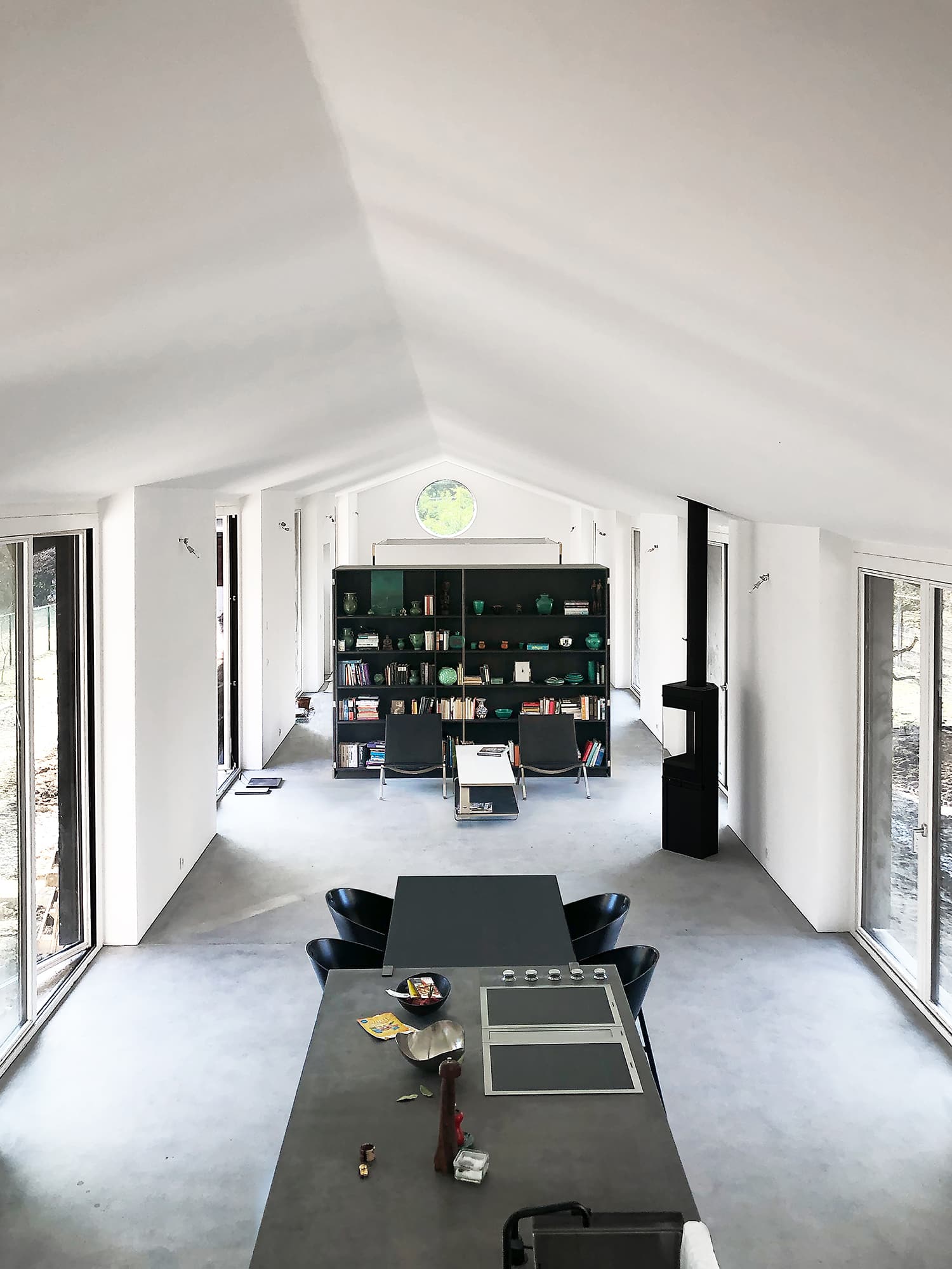 The Permanent Weekend House is a thin and long construction, extending an old chalet through its garden