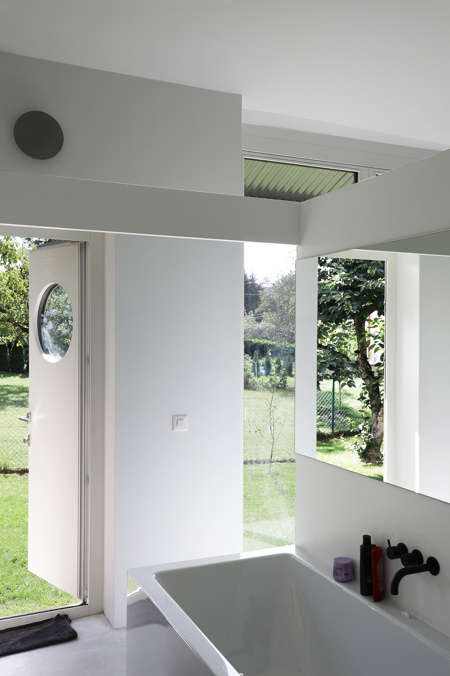 The Permanent Weekend House is a thin and long construction, extending an old chalet through its garden