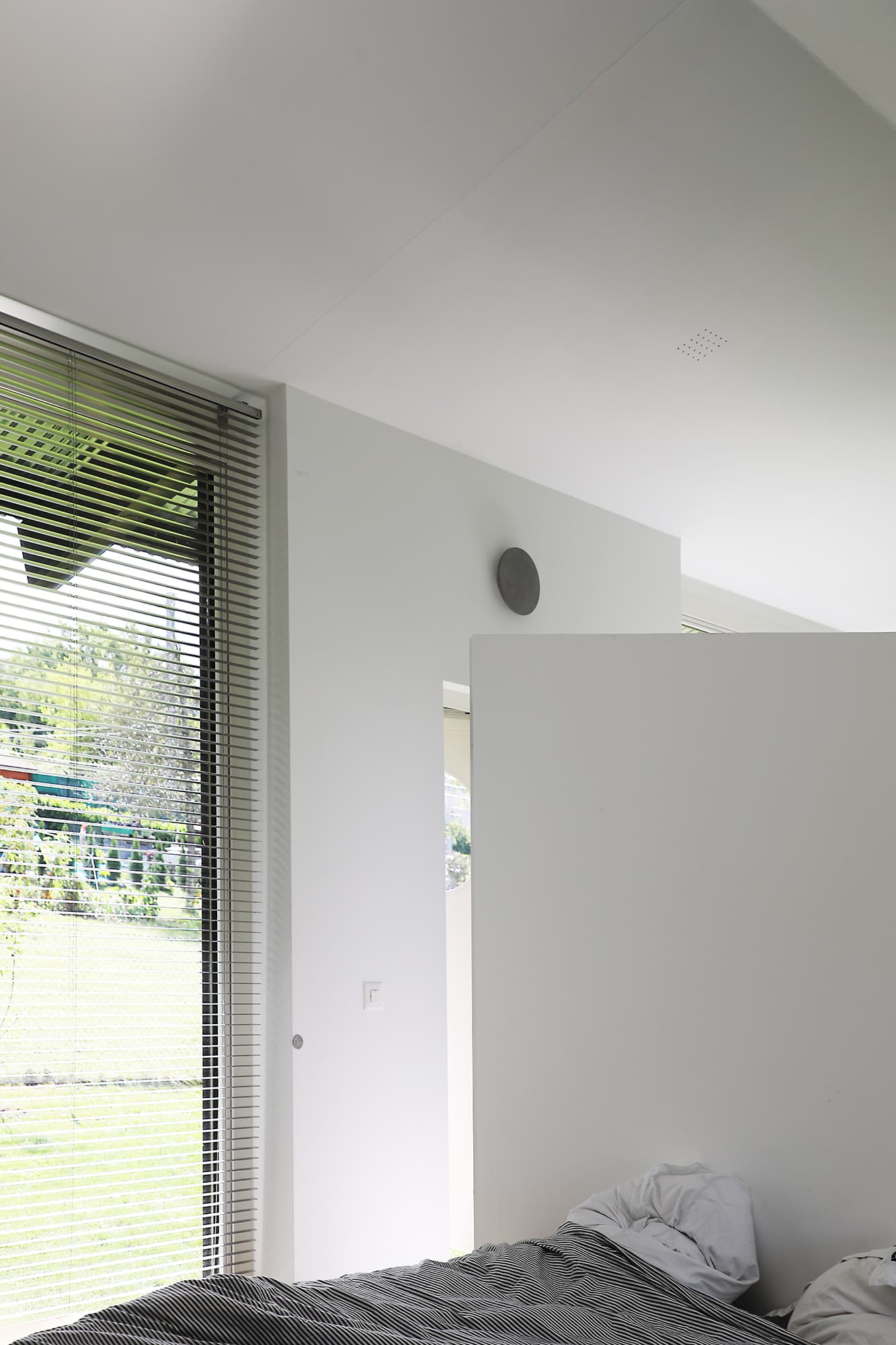 The Permanent Weekend House is a thin and long construction, extending an old chalet through its garden