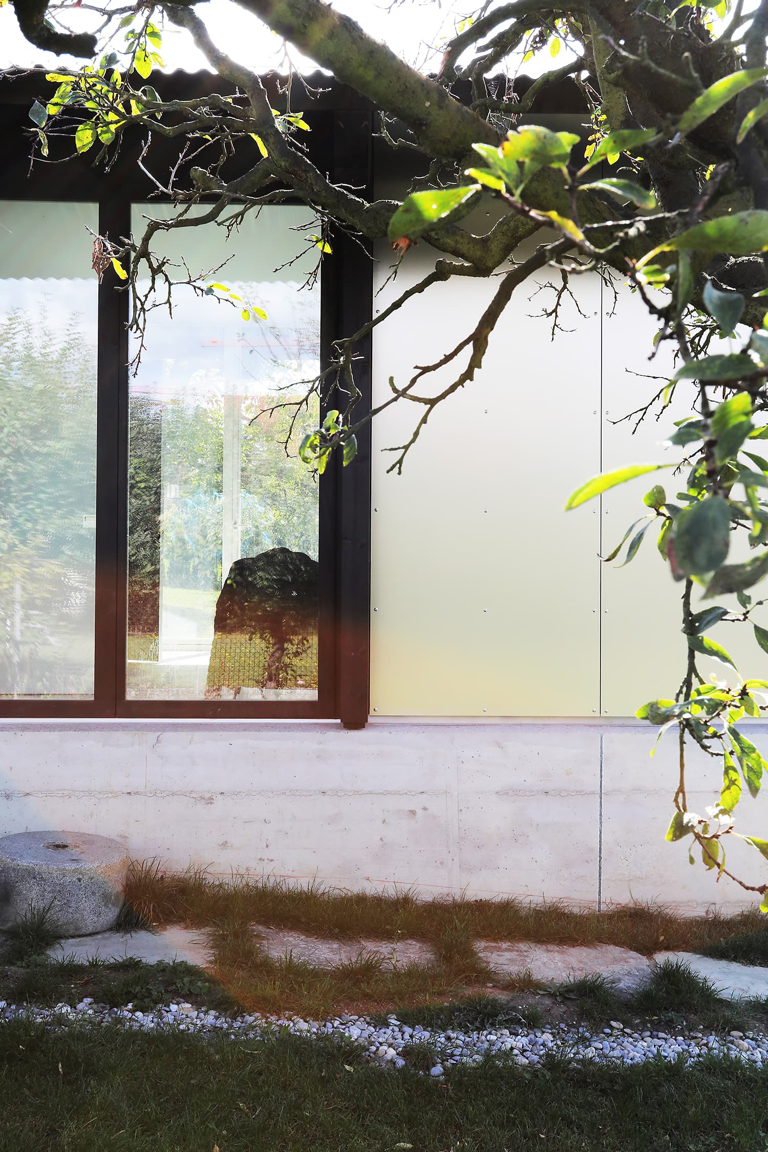 The Permanent Weekend House is a thin and long construction, extending an old chalet through its garden